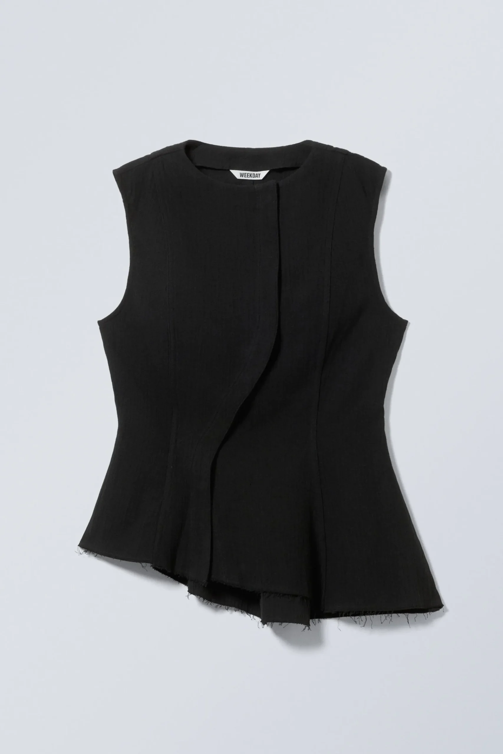 rmls_asymmetrisk_peplum_topp_3-1.webp Weekday Toppar<ÄRMLÖS ASYMMETRISK PEPLUM TOPP